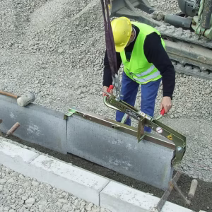 Kerbstone laying clamp to install concrete kerbstones.